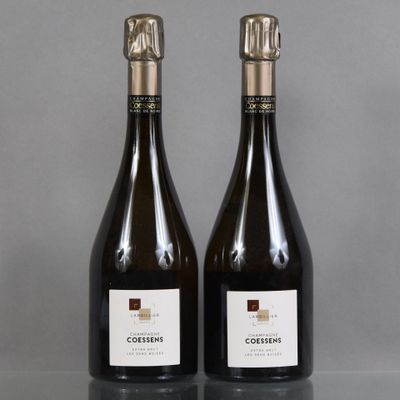 two bottles of wine sitting on top of a table next to each other