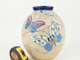 a vase with a tape and a tape measure on it