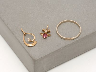 a close up of two rings and a ring with a bee on it