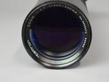 a close up of a camera lens on a white surface