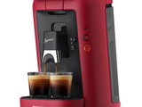 the philips coffee machine is red and has two cups of coffee in it