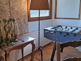 a foosball table in the corner of the living room