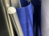 a blue umbrella that is hanging from a metal pole
