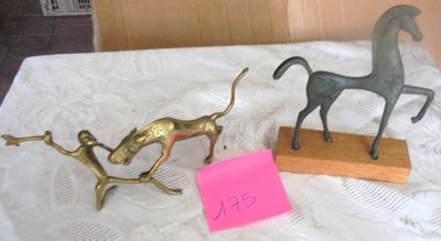 two figurines on a table with a note on it