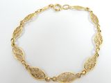 a close up of a gold bracelet on a white background