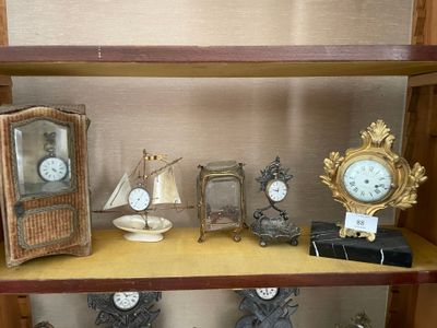 une étagère sur laquelle sont disposées de nombreuses horloges et autres objets