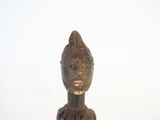 an old wooden statue of a woman with a hat on her head