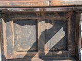 an old wooden bench with a shadow of a bird on it