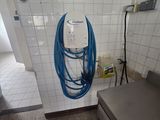 un tuyau bleu fixé au mur d'une salle de bains