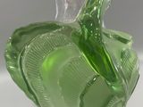 a green glass vase with a leaf design on it