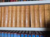 many books that are on a shelf in a library