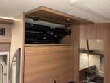 an image of a kitchen with wood cabinets and a stove