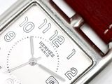 a close up of a wrist watch with a red strap