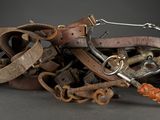 a pile of leather and metal items sitting on a table