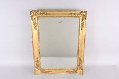 a gold framed mirror on a white surface