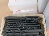 a bunch of drill bits in a box on a table