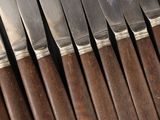 a lot of knives that are sitting on a table