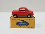 a red toy car sitting on top of a yellow box