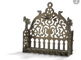 a metal shelf with a decorative design on it