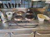a stove top with a pot on it in a kitchen