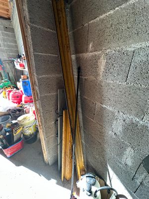 two skis leaning against a wall next to a fire hydrant