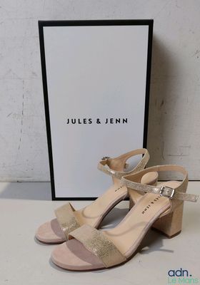 an image of a pair of nude colored sandals with a box in the background