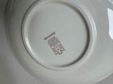 a white plate with a brown design on it