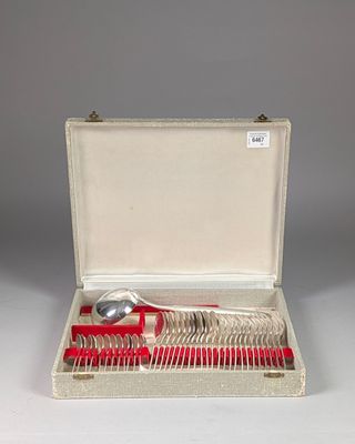 silverware in a case with a red handle and spoons in it
