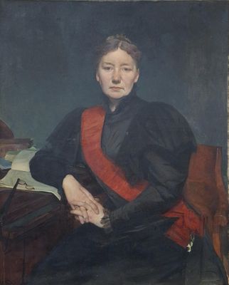 portrait of a woman in a red sash sitting at a desk