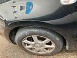 a close up of a black car with a blue sticker on the side of it