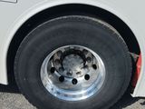 a close up of a tire on the side of a bus