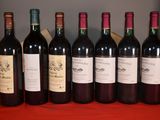 several bottles of wine are lined up on a table
