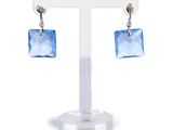 a pair of earrings with blue crystals hanging from them