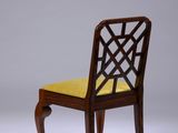 an image of a wooden chair with a yellow cushion on it
