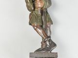 a statue of a man holding a cat on top of a table