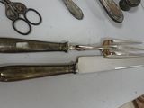 a lot of different types of knives and scissors on the table