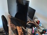 a desk with a computer and a monitor on it