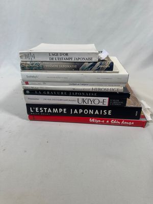 plusieurs livres empilés sur une surface blanche