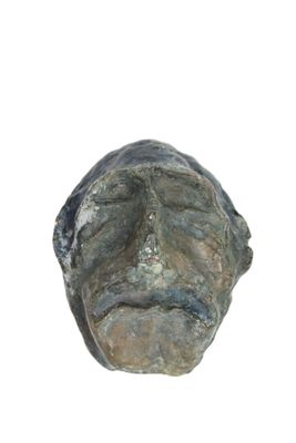 a sculpture of a man ' s face on a white background