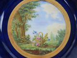 a blue plate with a picture of a basket of flowers on it