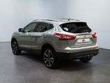 the rear end of a silver nissan suv parked in a room