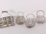 four small metal baskets with handles and handles on a white surface