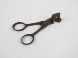 a pair of rusty scissors on a white surface
