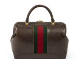 a brown leather bag with a green and red stripe on the side