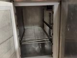 a stainless steel cabinet with a door open in a kitchen