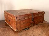 an old wooden box sitting on top of a wooden table