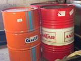 two red and one orange barrels sitting on a shelf
