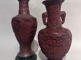two vases sitting next to each other on a table