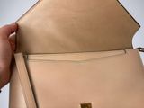 beige leather handbag with gold metal clasp