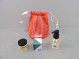 a small bag with a bottle of liquid and a small bottle of lotion